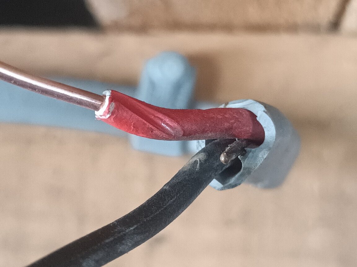 Close-up of a damaged cable with a broken circuit protective conductor found on a garage socket circuit