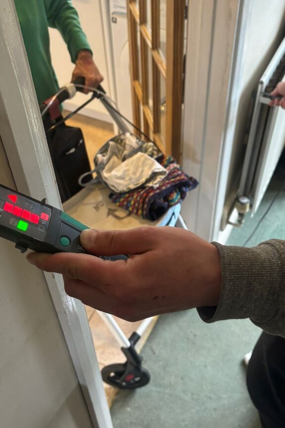 Electrical testing during an EICR confirming dangerous mains voltage on a metal switch plate